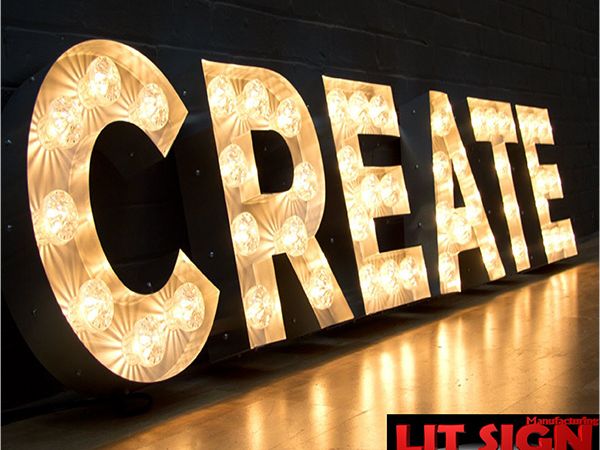 Custom marquee-bulb letters spelling CREATE