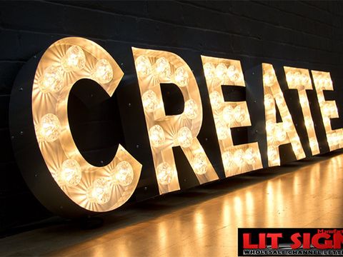 Custom marquee-bulb letters spelling CREATE